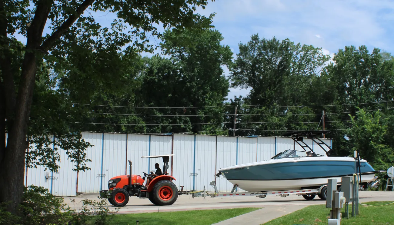 Valet launch — staff towing a boat to the water